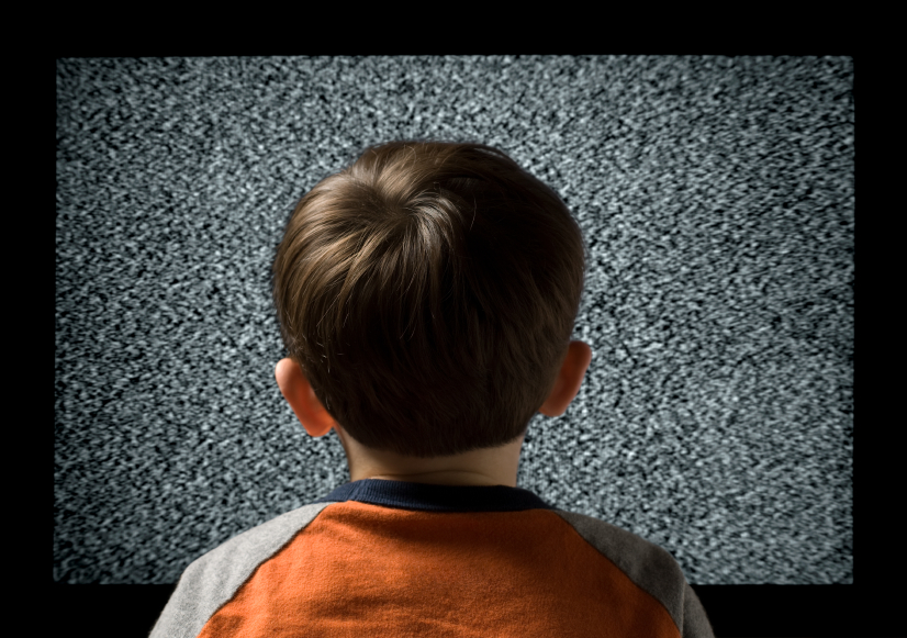 Young male child watching television metaphor
