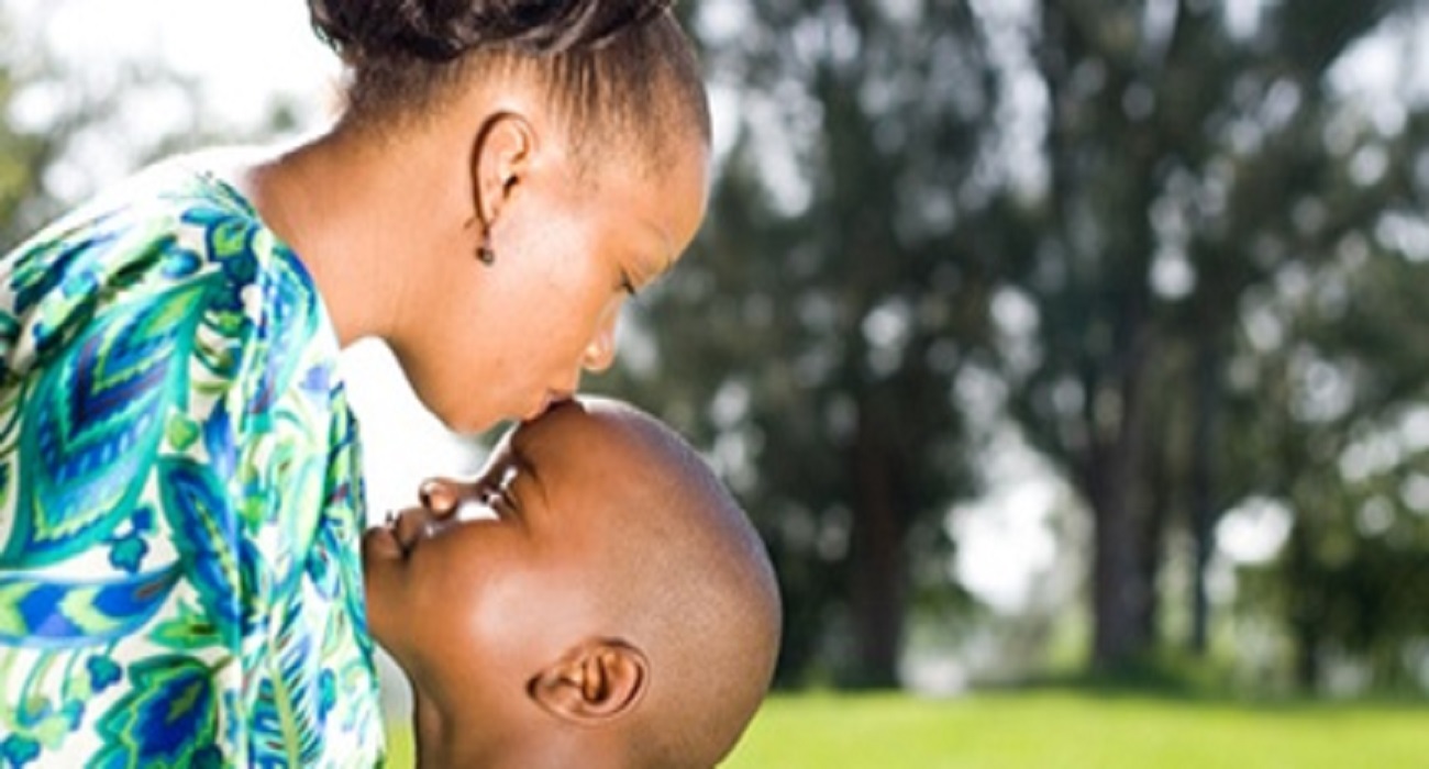 African mother kissing her boy child
