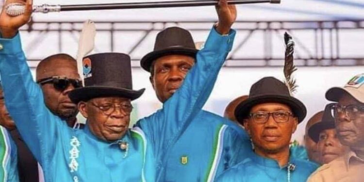 President Bola Tinubu raising his hands at a political campaign rally