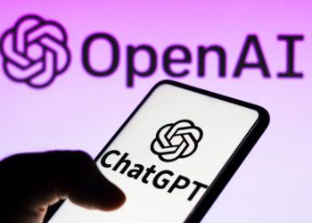 Smartphone displaying ChatGPT app with OpenAI logo on a purple background.
