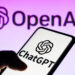 Smartphone displaying ChatGPT app with OpenAI logo on a purple background.