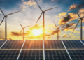 Solar panels and wind turbines generating renewable energy at sunset