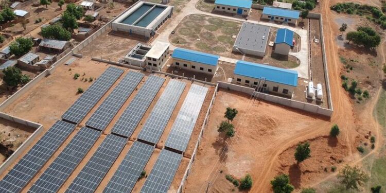 Aerial view of Eauxwell facility with solar panels and buildings.