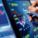 Hand analyzing stock market chart on table